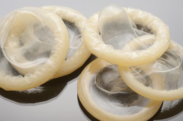Pile of plain latex unused condoms for practising safe sex preventing the spread of sexually transmitted disease and pregnancy