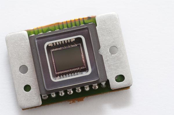 macro image of the sensor chip from a CCD camera, tiny gold wires connect the silicone die to the pins on the edge of the device