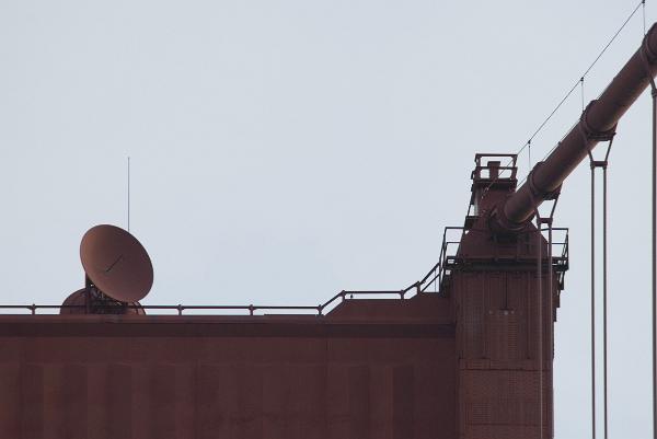looking up at the south tower, golden gate bridge,the microwave communications dishes placed on the structure are painted the match the colour of the bridge instead of the usual white colour - why are they normally coloured white?