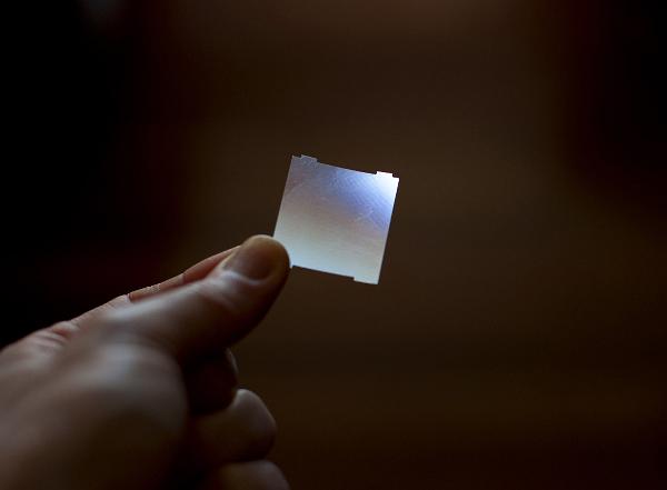 a thin plastic sheet with microscopic groves is seen here bending light from elsewhere in the room