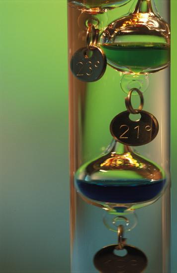 Floats in a Galileo thermometer, made of a sealed glass cylinder containing a clear liquid and several glass vessels of varying densities that rise and fall with temperature changes.