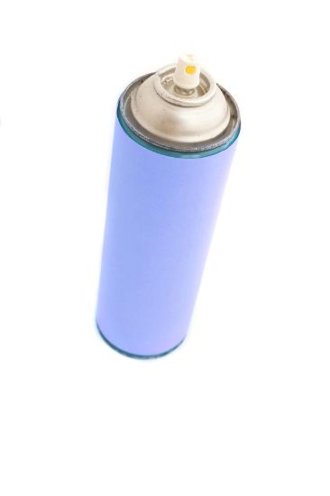 Unlabeled aerosol can with plain purple sticker and without a cap, viewed from high angle isolated on white background