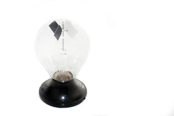 a crookes radiometer or light mill on a white background