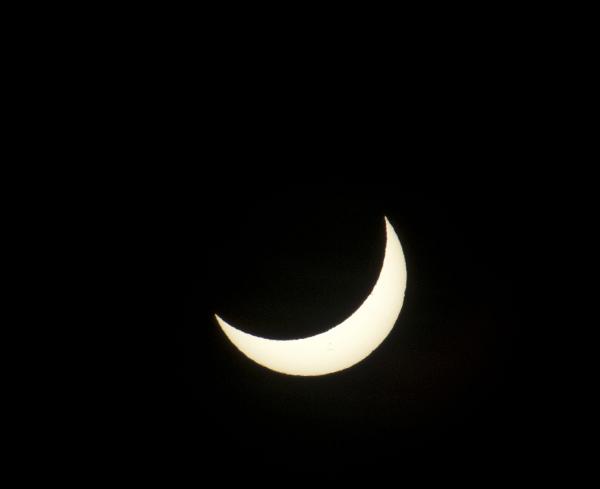 crescent sun before an eclipse, with sunspots visible