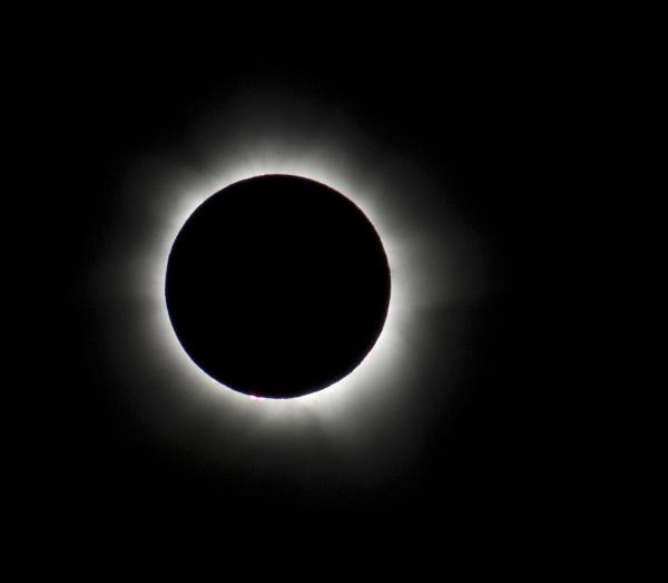 An eclipse in totality, prominences can be seen as can the light reflection from the suns corona