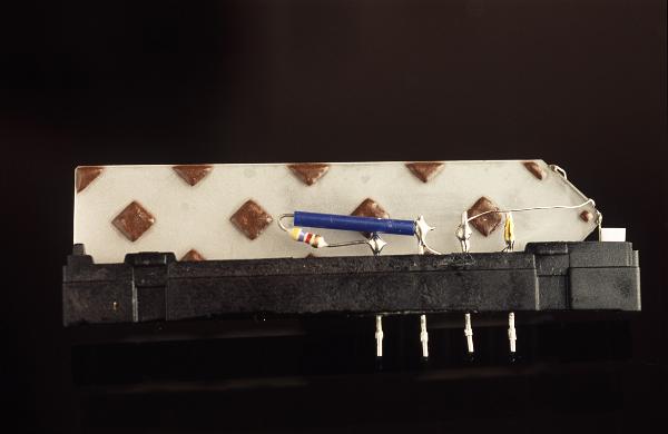 Analogue delay line designed to introduce a calculated delay into the transmission of a signal using a think wafer of glass and a surface skin effect