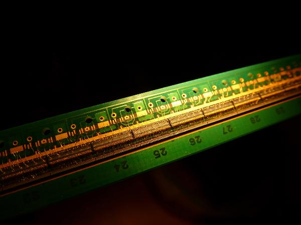 A close up of a linear LED array and circuit board on a black background with copy space.