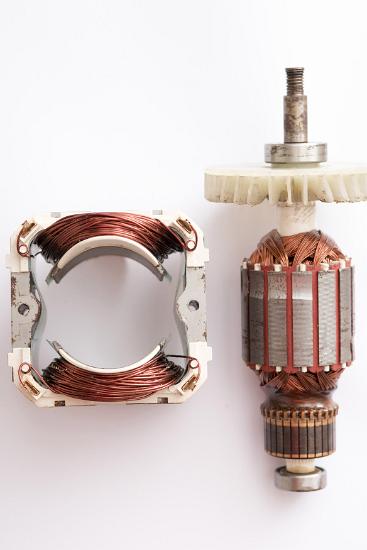 Motor stator and rotor on a white background Close up detail of a motor stator and rotor from a universal AC DC motor on a white background with copy space