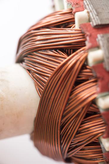 Close up detail of copper motor windings with selective focus to the wires in centre frame