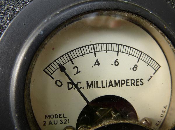 Old fashioned milliammeter gauge Old fashioned milliammeter gauge in a close up view on the readout measuring current in a DC circuit
