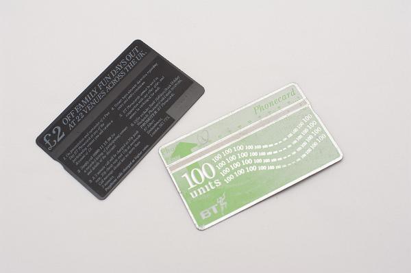 Old UK phone cards on background with copy space Two old UK phone cards on a white background with copy space.