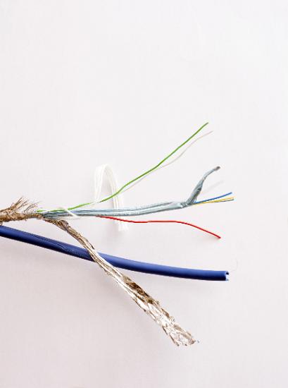 USB cable twisted pairs with the insulating foil opened and displayed over a white background, the foil lection is used to screen the data carried by the cable from RF noise
