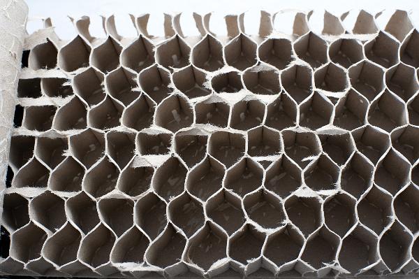 cardboard interior of an internal door, the hollow honeycomb structure reinforces the door, when glued to panel on either side creates a strong ridget structure