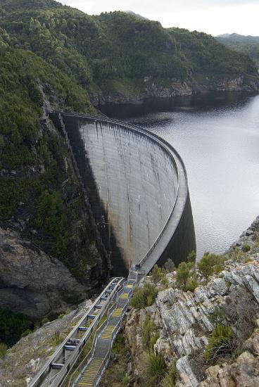 gordon river dam the gordon river dam, tasmania, the double curvature of the dam wall distributes the force of the water behind the dam sideways into the canyon wall