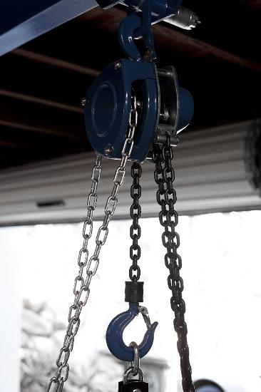 Heavy duty lifting block and tackle mounted to a roof and fitted with a large hook and chain