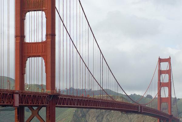 suspension bridge looking along the golden gate bridge from the south end, san francisco, the cables form a parabolic curve due to the weight of the road dack suspended from them