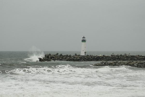 coastal defences Santa cruz harbour navigation lighhouse on a stormy day as wavers crash onto the man made breakwater
