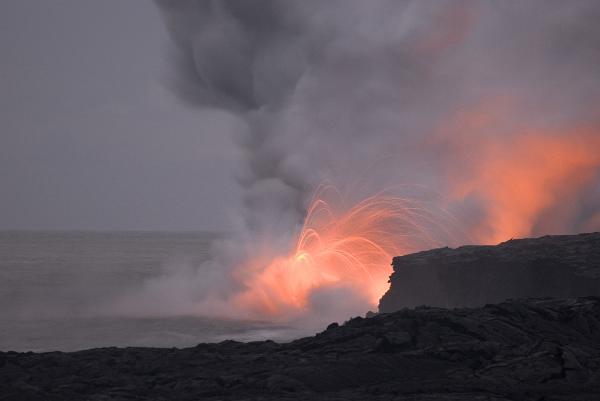 red hot lava shooting through the air into the sea makes a spectacle for travellers visiting hawaiiis big island, Hawaii, USA